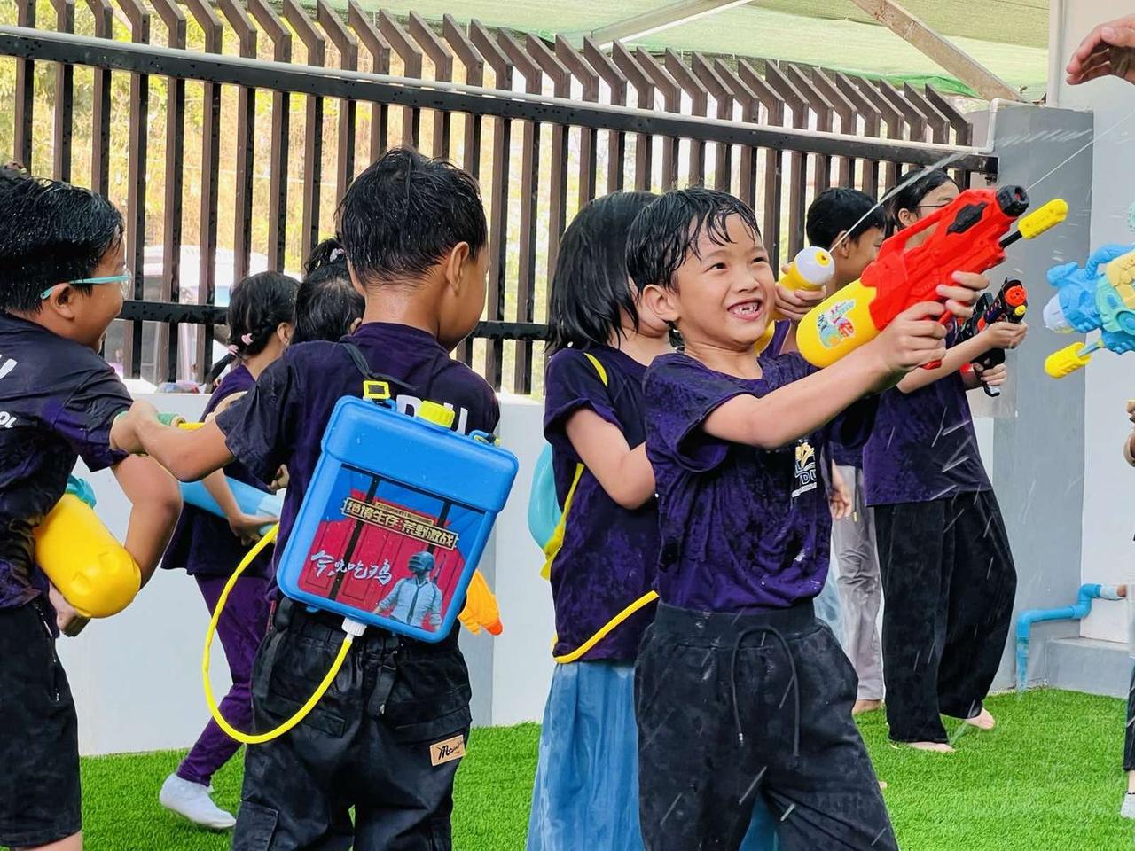 Students playing with water guns at the Myanmar Water Festival
